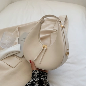 Minimalist cream white leather crescent hobo bag for women with elegant gold hardware