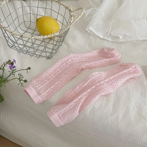 Close-up of pink hollow-out knit cotton socks with delicate heart and wave patterns