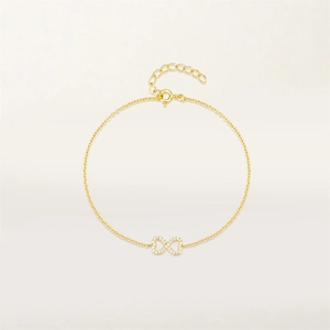 Detail of infinity gold bracelet with sparkling white zircons and adjustable chain