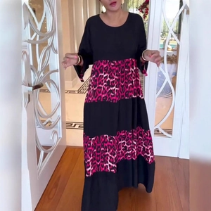 Detail of elegant leopard print patchwork maxi dress with round neck and long sleeves