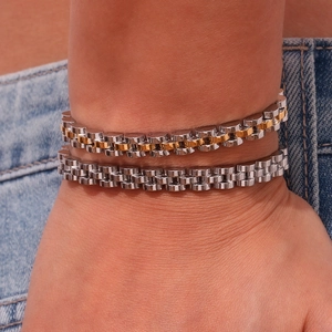 Detail of 6mm two-tone and silver Jubilee style link chain bracelets on denim fabric