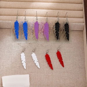 Bohemian feather tassel earrings in five colors displayed on a beige jewelry box