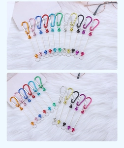 Colorful D-ring metal carabiner assortment on a soft white plush background for DIY keychains