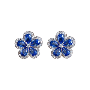 Silver needle flower earrings with blue teardrop stones and micro-pave cubic zirconia