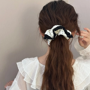 Vintage white hair scrunchie with black polka dots and lace trim shown on hair