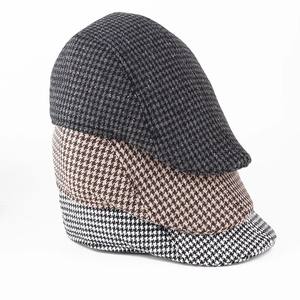 Classic houndstooth beret hats in black, brown, and grey with warm brushed fabric texture