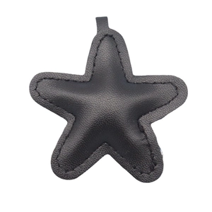 Minimalist black leather star-shaped keychain with stitched edges and pendant ring