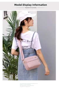 Pink nylon crossbody bag shown on a model featuring multiple zippers and casual style