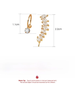 Detailed specs of gold ear cuff set with cubic zirconia stones on polished copper base