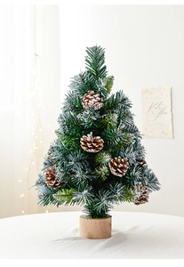 Mini artificial Christmas tree with frosted pine cones and a rustic wooden base