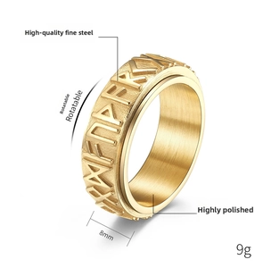 Detail shot of 8mm golden rotatable stainless steel ring with Nordic rune engraving