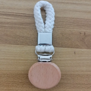 Close-up of woven cotton towel clip with round wooden clamp and metal hardware