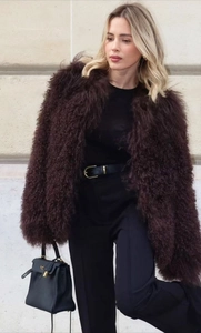 Detail of deep brown shaggy faux fur coat with fluffy texture and oversized lapel design