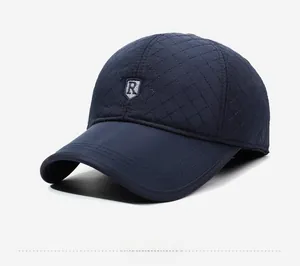 Close-up of diamond quilted texture and embroidered R logo on blue baseball cap