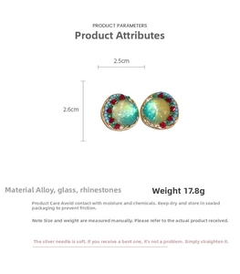 Macro detail of geometric round earrings with blue-green glass and red rhinestones