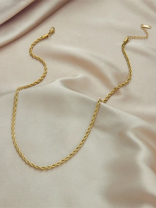 Close-up of gold twist chain necklace on champagne silk with lobster clasp and extender