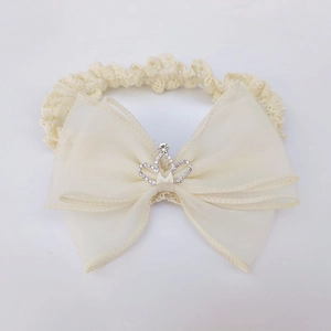 Detailed view of beige lace baby headband featuring mesh bow and sparkly silver crown