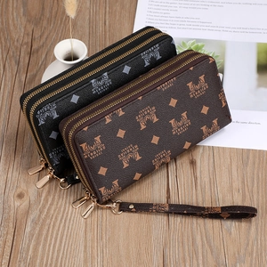 Detail of double zipper long wallets in black and brown with monogram print