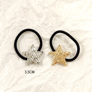 Detailed view of gold and silver hollow star hair ties with 3.5CM metallic star charms