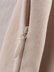 Detailed close-up of beige twill fabric with matching invisible water-drop zipper