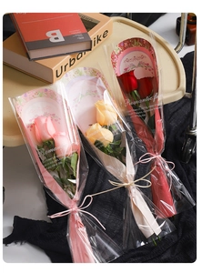 Detail view of single rose bouquets with Romantic Floral text and elegant bow ties
