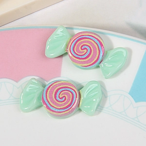 Macro view of colorful resin candy swirl charms for DIY hair accessories and phone cases
