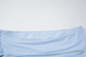 Detailed close-up showing light blue mesh fabric texture and stitching of the dress