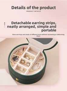 Detail of dark green travel jewelry box showing detachable earring organizer plate