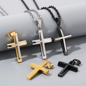 Detailed view of titanium steel cross necklaces in gold, silver, and black metallic finishes
