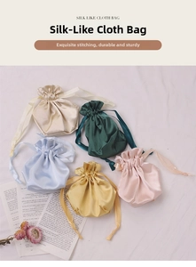 Flat lay of satin drawstring pouches in champagne, green, blue, yellow and pink