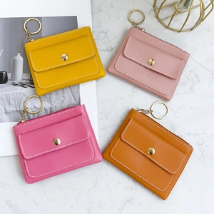 Faux leather coin purses with snaps and gold keychains in yellow, pink, and orange