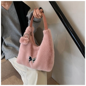 Pink faux fur handbag featuring a silver butterfly buckle and matching plush ball charm