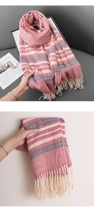 Detail of warm striped scarf with herringbone weave texture and cream tassels