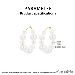 Detail showing French style U-shaped stainless steel hoop earrings with graduated shell pearls
