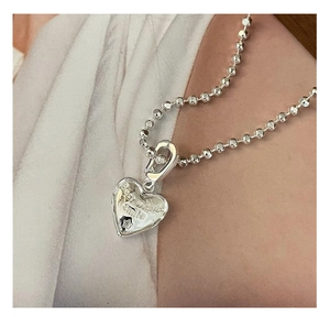 Close-up of S925 sterling silver heart pendant with best wishes engraving and star detail