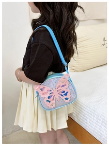 Rear view of a child wearing a sequined butterfly crossbody bag with adjustable strap