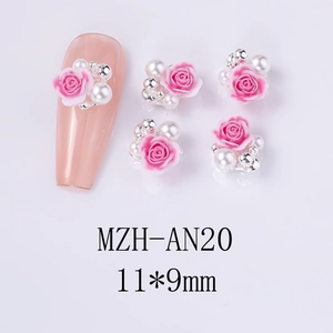 Detailed view of 11x9mm pink resin rose and pearl nail art charms on a nude manicure
