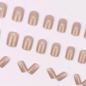 Short square champagne pink press-on nails with shimmering cat-eye metallic finish
