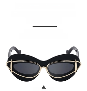 Detail of trendy cat-eye sunglasses with UV protection and gold metal trim accents