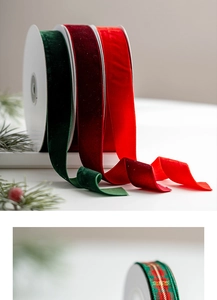 Close-up of luxury velvet Christmas ribbons in dark green and red on pine branches