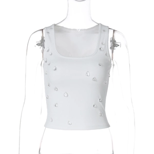 Detail of white ribbed knit tank top featuring transparent teardrop bead decorations