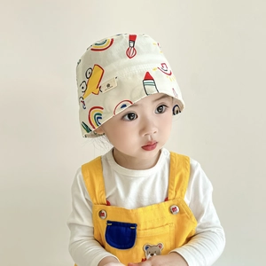 Toddler sun bucket hat with colorful cartoon graffiti print on creamy white cotton fabric