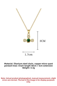 Detail of titanium cross necklace with green gemstone and micro-inlaid crystals