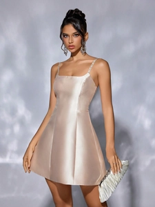 Champagne gold satin mini dress with rhinestone straps and an elegant A-line silhouette
