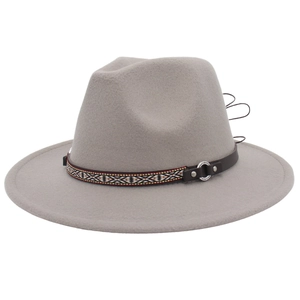 Detail of grey felt fedora featuring ethnic geometric band and leather strap with studs