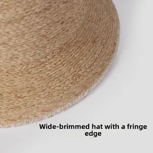 Detail of raffia straw hat edge with unique frayed fringe trim and woven texture