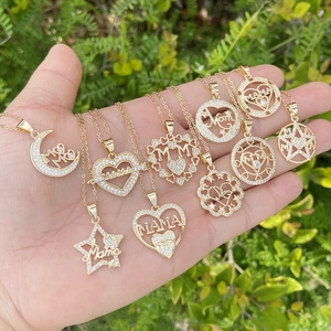Close-up of gold-plated necklaces with cubic zirconia MAMA and Mom heart pendants