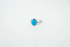 Close-up of a silver stainless steel ring with an oval blue turquoise stone inlay