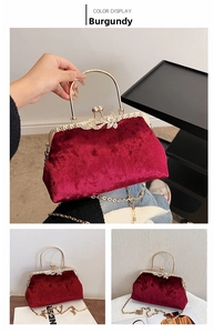 Close-up of burgundy velvet evening bag with gold handle and sparkling bow clasp