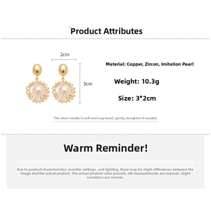 Detailed view of flower-shaped 18k gold earrings with large pearl center and zircons